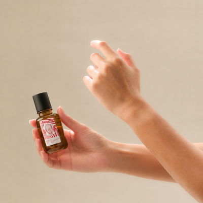 Spraying Oil de Parfum onto the inner wrist